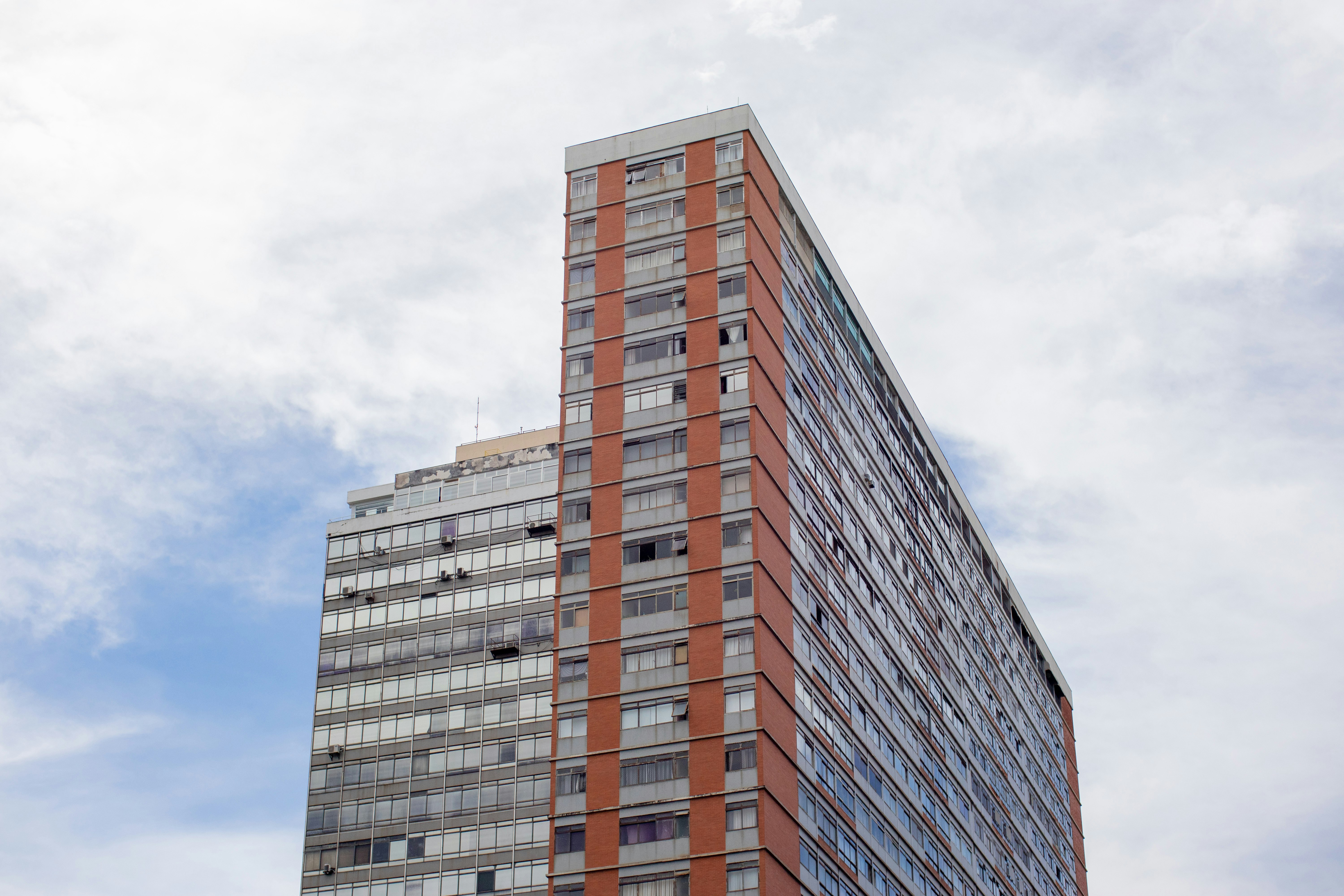 brown and gray concrete building under white clouds during daytime